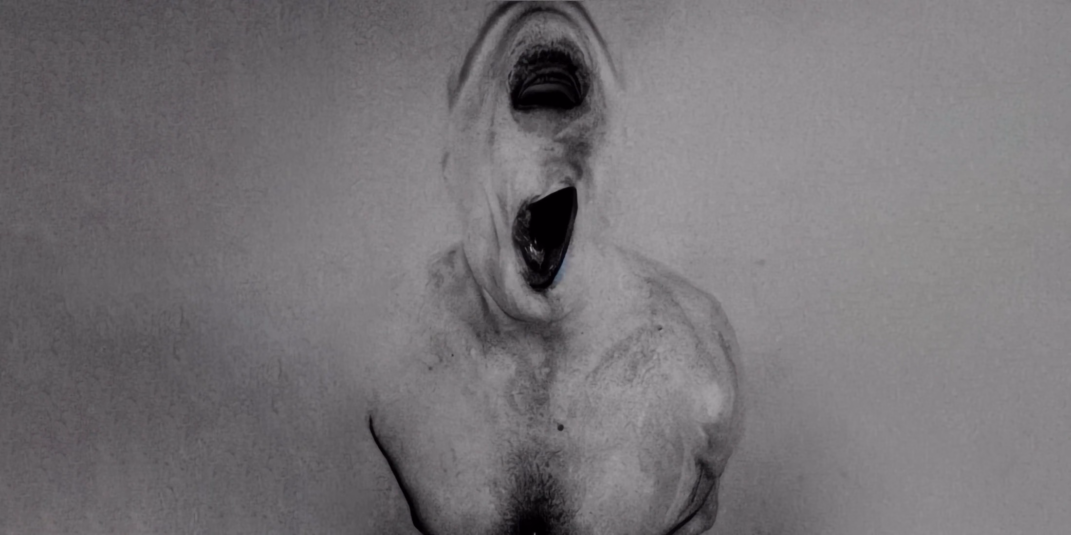 An indistinct monochrome figure with an open mouth