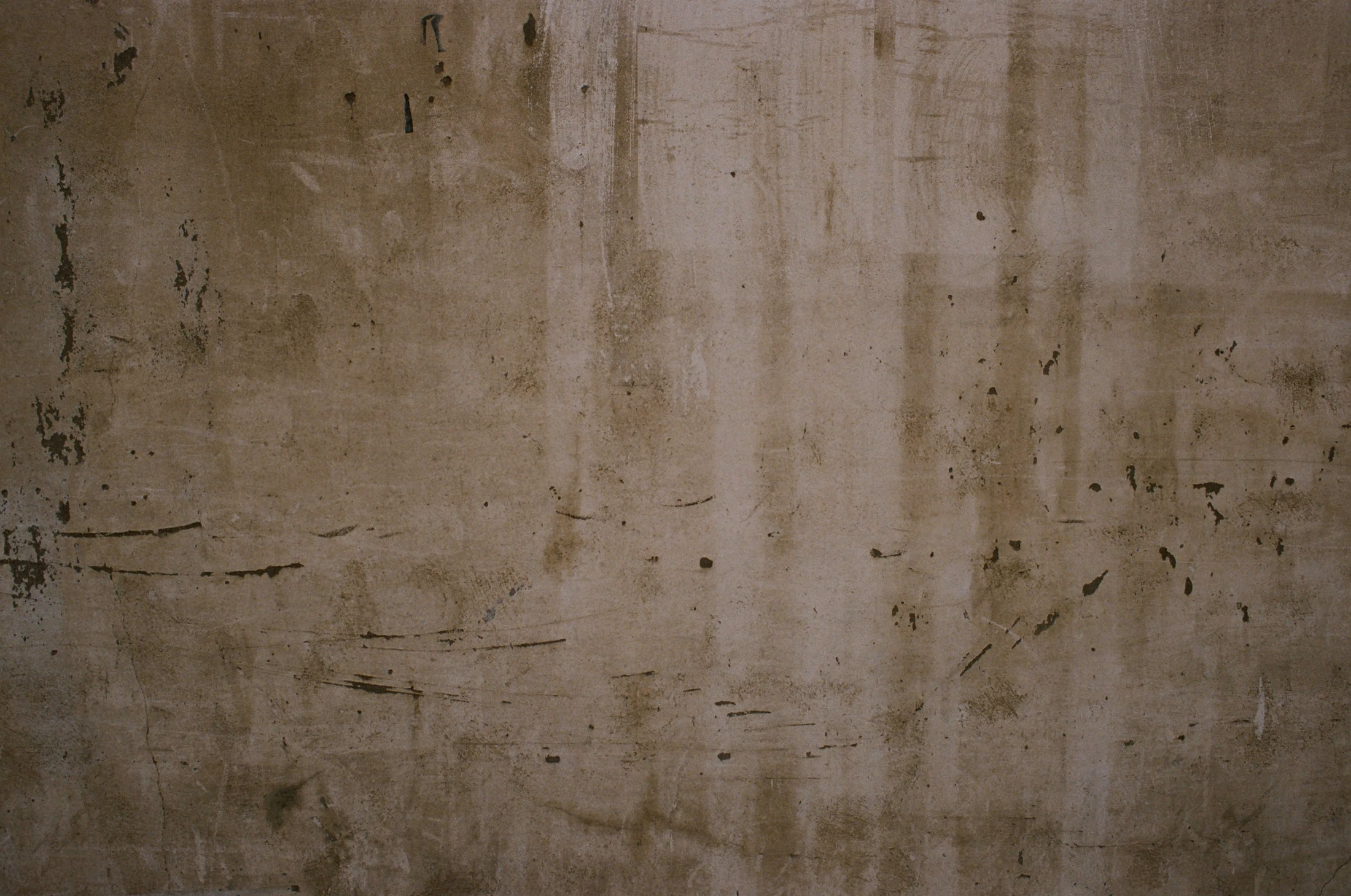 Pale wall marked with vertical streaks and dark traces