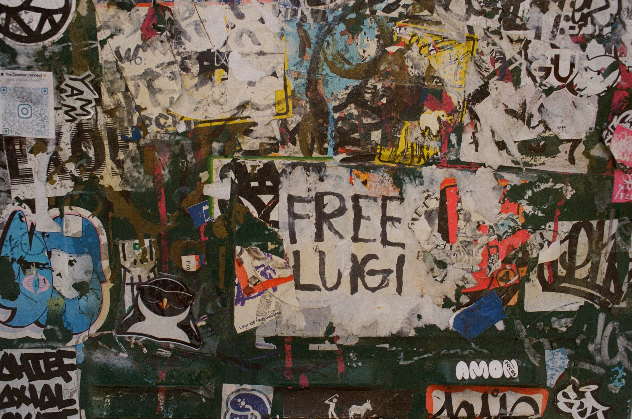 Layers of torn posters and handwritten messages